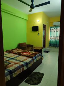 a bedroom with a bed and a flat screen tv at Hotel New View in Chittagong