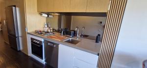 a small kitchen with a sink and a refrigerator at Ascot Hill in Melbourne +17 photos
