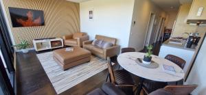 a living room with a table and a couch at Ascot Hill in Melbourne