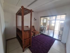 a room with a mirror and a chair and a table at Bird Retreat in Zeekoevlei