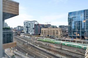 a view of a city with train tracks and buildings at Sunny Downtown TO Studio - Sleeps 3 with 55 TV in Toronto