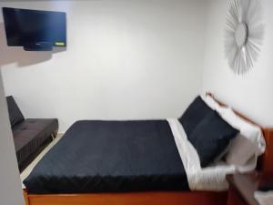 a small bedroom with a bed and a couch at Casa Alto de la Virgen DeMaiz in Choachí