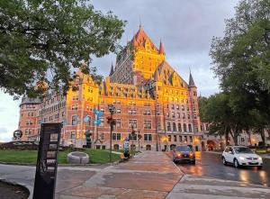 een groot geel gebouw met auto's die ervoor rijden bij District 202 Loft in Québec