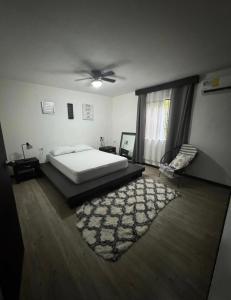 a bedroom with a bed and a ceiling fan at Casa Bambu in Tapantí