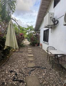 a patio with a table and an umbrella next to a building at Casa Bambu in Tapantí