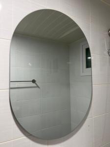 a mirror on a wall in a bathroom at Wayhome Gasan in Seoul +47 photos