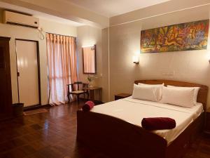 a bedroom with a large bed in a room at Omega Regency Colombo in Colombo +10 photos
