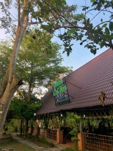 a restaurant with a sign on the top of a building at Nam Cat Tien Retreat in Tân Phú