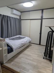 Ένα ή περισσότερα κρεβάτια σε δωμάτιο στο Manga House Awesome Shino