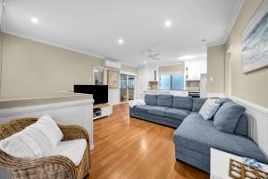 a living room with a couch and a tv at Cypress Sea Breeze in Woorim