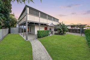 a house with a green yard in front of it at Cypress Sea Breeze in Woorim