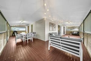 a house with a deck with a table and chairs at Cypress Sea Breeze in Woorim