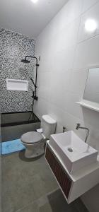 a bathroom with a toilet and a sink at Pousada Paraíso Guapi in Guapimirim +9 photos