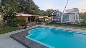 a swimming pool in the backyard of a house at Chaba3 in Ban Nong Bua Noi