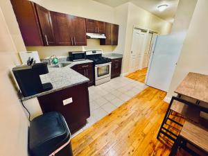 a kitchen with wooden cabinets and a counter top at Modern Luxury Executive Room with NYC Fast Access in Paterson