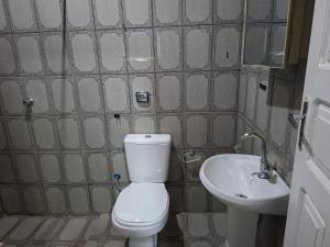 a small bathroom with a toilet and a sink at Residencial Paraviana-Casa Piscina in Boa Vista +11 photos