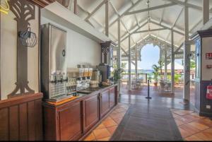 a kitchen with a counter in a building at Couleur Caraïbes- 2 Appartements Communicants Vue Mer CLUB DE VACANCES in Sainte-Luce