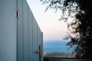 a door to a building with a large window at Divino Suites in Fira +59 photos