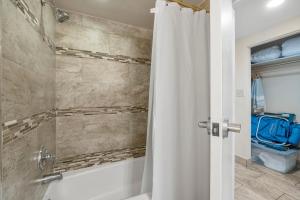 a bathroom with a shower with a shower curtain at Sandestin Bayfront Studio with balcony and breathtaking views in Destin +37 photos