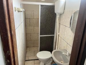 a small bathroom with a toilet and a sink at Pousada Sossego in Pojuca