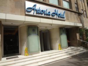 a store front of a building with a sign on it at Astoria Hotel in Mumbai