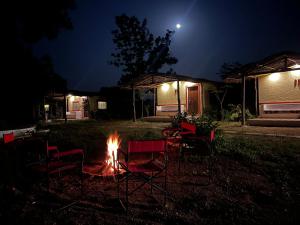 a fire pit in a yard at night at Home in the Jungle in Seonī