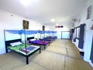 a room with four bunk beds in it at Manel Guesthouse and Restaurant in Senmonorom