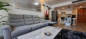 a living room with a couch and a table at Stylish New Condo in NANA in Bang Kapi