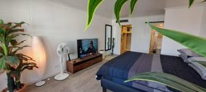 a bedroom with a bed and a flat screen tv at Stylish New Condo in NANA in Bang Kapi