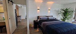 a bedroom with a bed with a blue comforter at Stylish New Condo in NANA in Bang Kapi