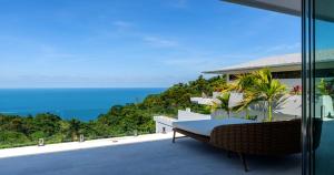 a view of the ocean from the balcony of a house at BLUE BUTTERFLY Luxury Pool Villa Koh Samui 5 Bedrooms in Koh Samui  +25 photos