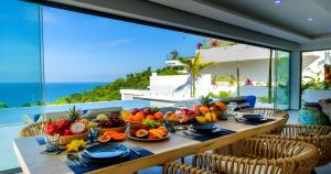 a table with fruits and vegetables on a balcony at BLUE BUTTERFLY Luxury Pool Villa Koh Samui 5 Bedrooms in Koh Samui 