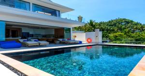 a swimming pool in front of a house at BLUE BUTTERFLY Luxury Pool Villa Koh Samui 5 Bedrooms in Koh Samui 