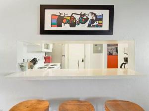 une cuisine avec un comptoir blanc avec deux tabourets dans l'établissement 2 Bedroom 1 Bath Condo, à Fort Myers
