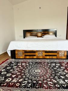 a bedroom with a bed with a rug on the floor at Home in the Jungle in Seonī