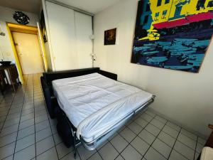 a bed in a room with a painting on the wall at Studio cabine à Port Argelès avec loggia et parking privatif - FR-1-309-416 in Argelès-sur-Mer