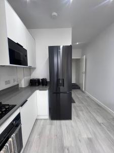 a kitchen with a stainless steel refrigerator in it at The Central Haven in Manchester +17 photos
