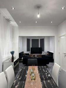 a living room with a table and a couch at The Central Haven in Manchester