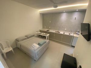 una camera con letto e lavandino e un bagno di Kitnet Standard Araujo's Suítes 107 a Passos Altre 12 foto