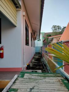 an empty hallway of a building with a sidewalk at Soi Saliga in Rawai Beach