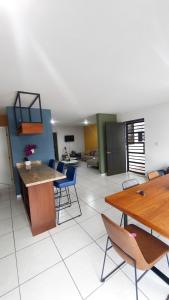 a living room with tables and chairs and a couch at Condominio mzt in Mazatlán