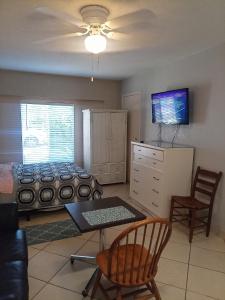 a bedroom with a bed and a table and chairs at Pinellas Park Oasis in St Petersburg