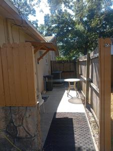 a patio with a table and a fence at Pinellas Park Oasis in St Petersburg
