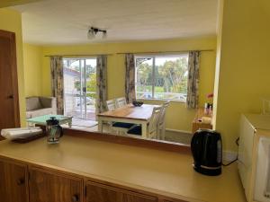 a kitchen with a table and a large mirror at Buena Vista in Geraldine +8 photos