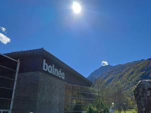 a building with a sign on the side of it at Maison pour 5 à Génos proche lac et station avec WiFi - FR-1-695-94 in Génos +1 photo