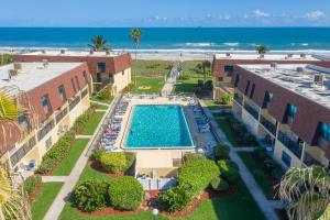 an aerial view of a resort with a swimming pool and the beach at Cocoa Beach Club 206 in Cocoa Beach