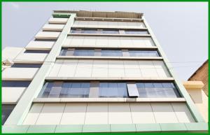 a tall building with a lot of windows at Mahakaleshwar jyotilinga Temple Dwarika - Dhish Premium near Railway station, Fully Air conditioned Rooms -wifi- Lift and Restaurant Facilities, BEST HOTEL IN UJJAIN in Ujjain