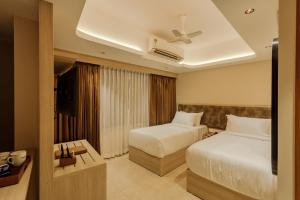 Ένα ή περισσότερα κρεβάτια σε δωμάτιο στο Olwen Suites +30 φωτογραφίες