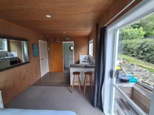 a kitchen and living room in a tiny house at Tairua Getaway in Tairua +5 photos