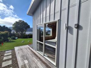 a sliding glass door on the side of a building at Tairua Getaway in Tairua